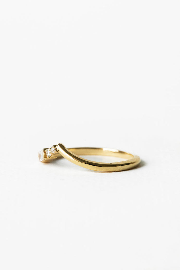 Curved V moissanite wedding band in yellow gold, side view