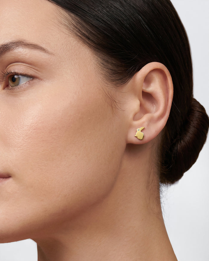 Model wearing round bunny lab grown diamond stud earrings, close up on the ear