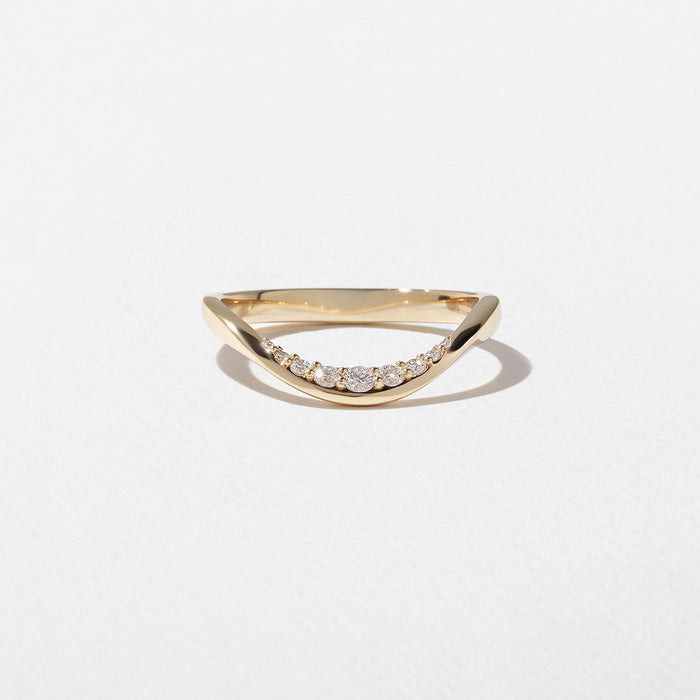 Round moissanite curved wedding band in yellow gold front view