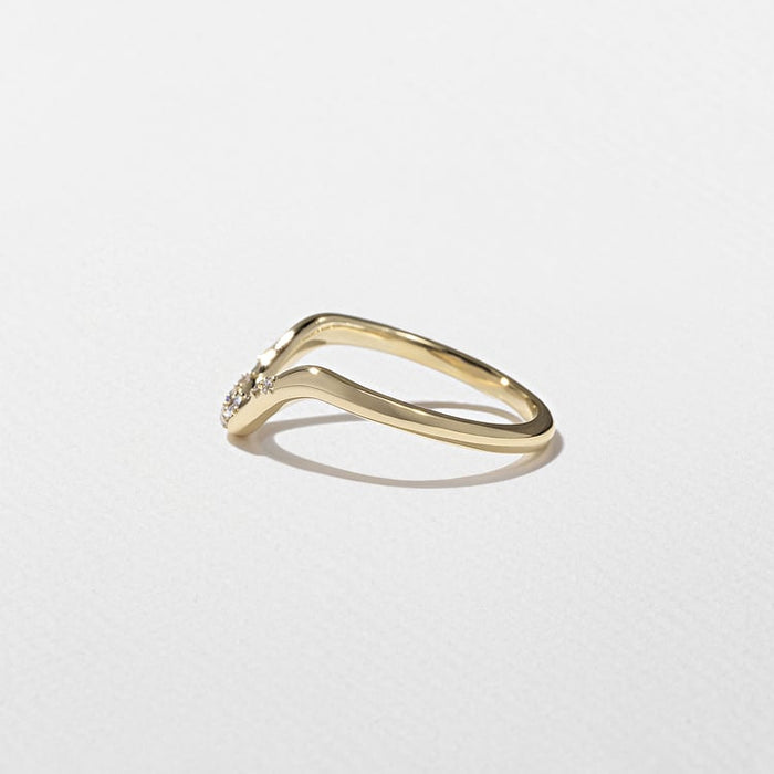 Angled view of the curved band with scattered round moissanite stones