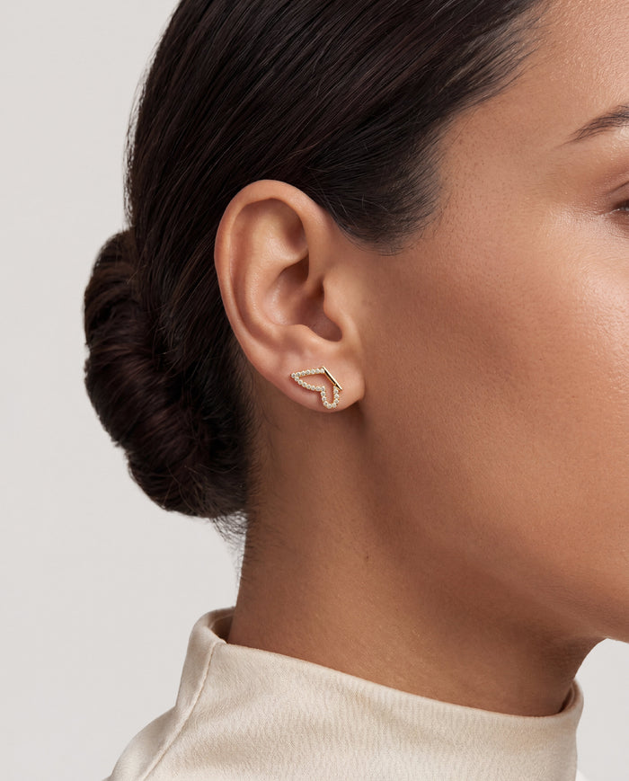 Model wearing round pave butterfly outline lab grown diamond stud earrings, close up on the ear
