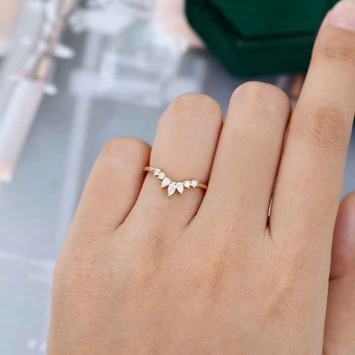 Round, Pear and Marquise moissanite crown curved wedding band, worn on the finger in yellow gold