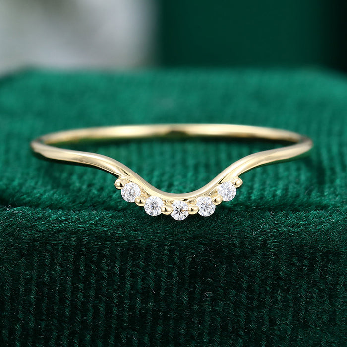 Round moissanite wave curved wedding band, front view in yellow gold