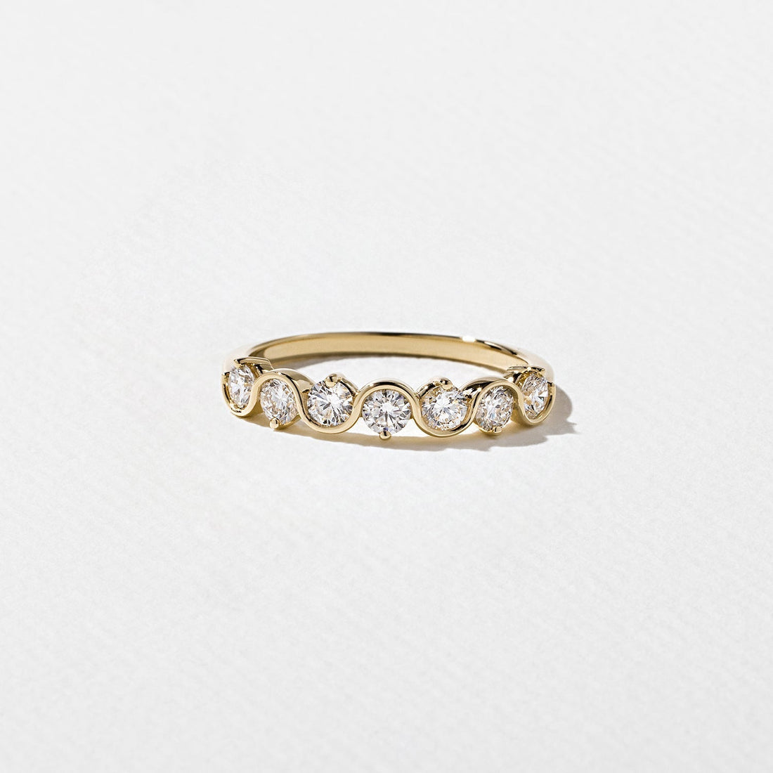 Round lab grown diamond bezel half eternity wedding band, front view
