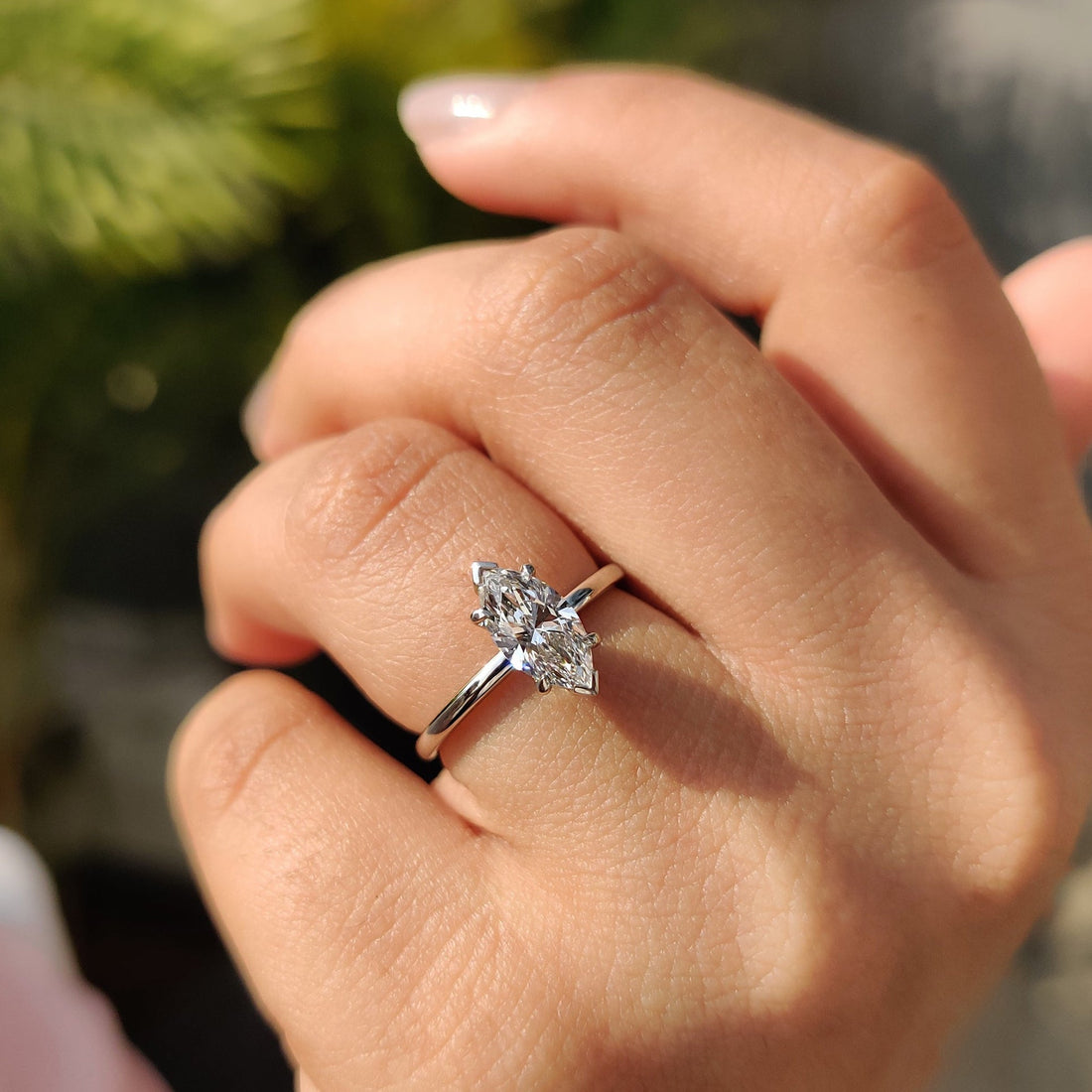 Marquise cut lab grown diamond solitaire engagement ring on a plain white gold band