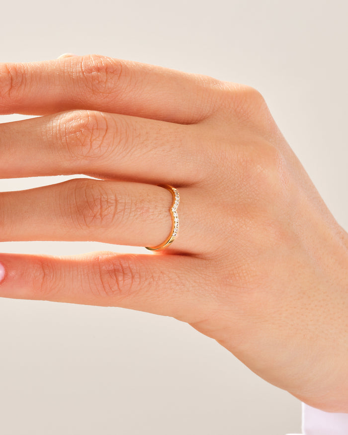 V-shaped moissanite wedding band worn on the ring finger