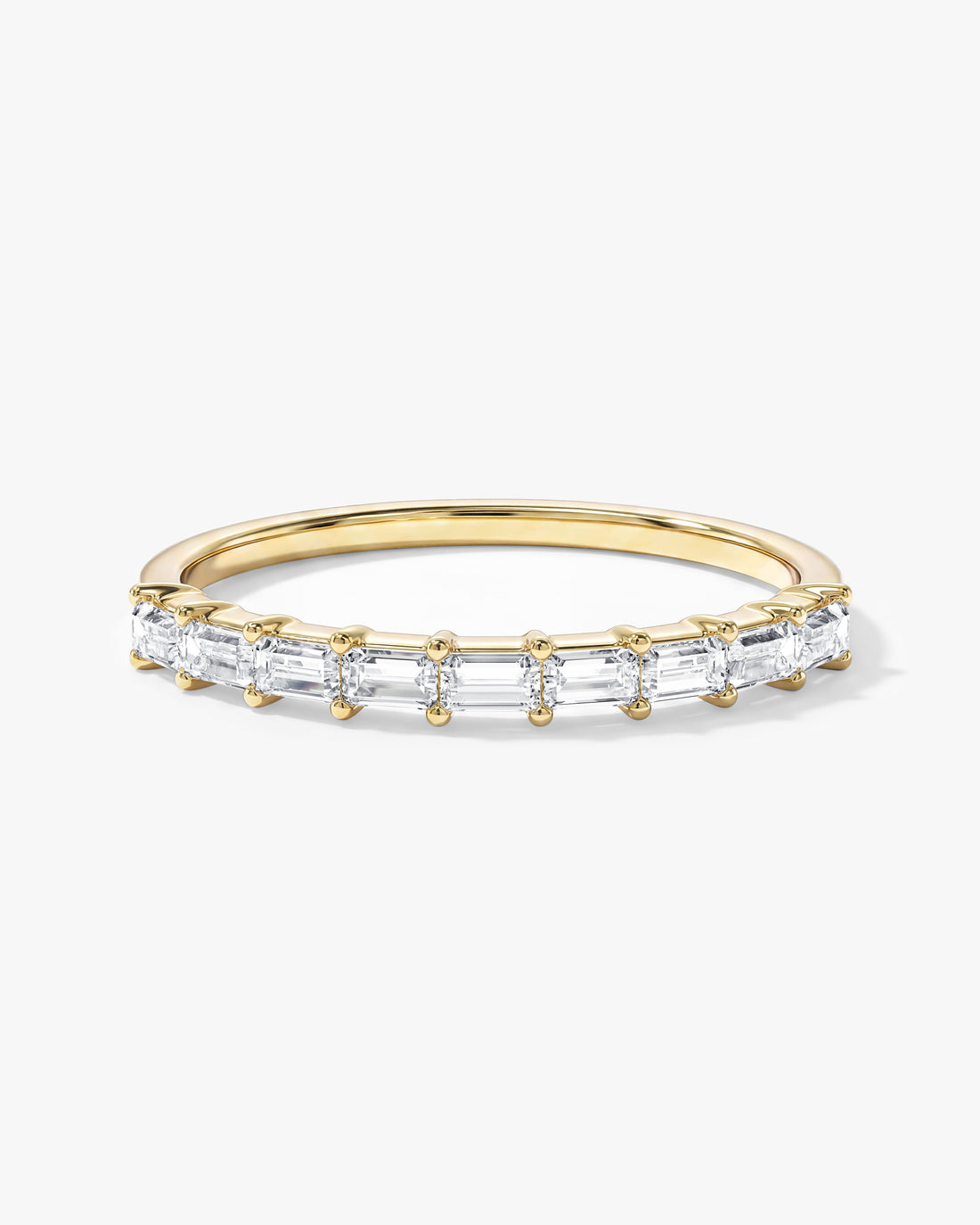 Horizontal baguette moissanite half eternity wedding band in yellow gold, front view
