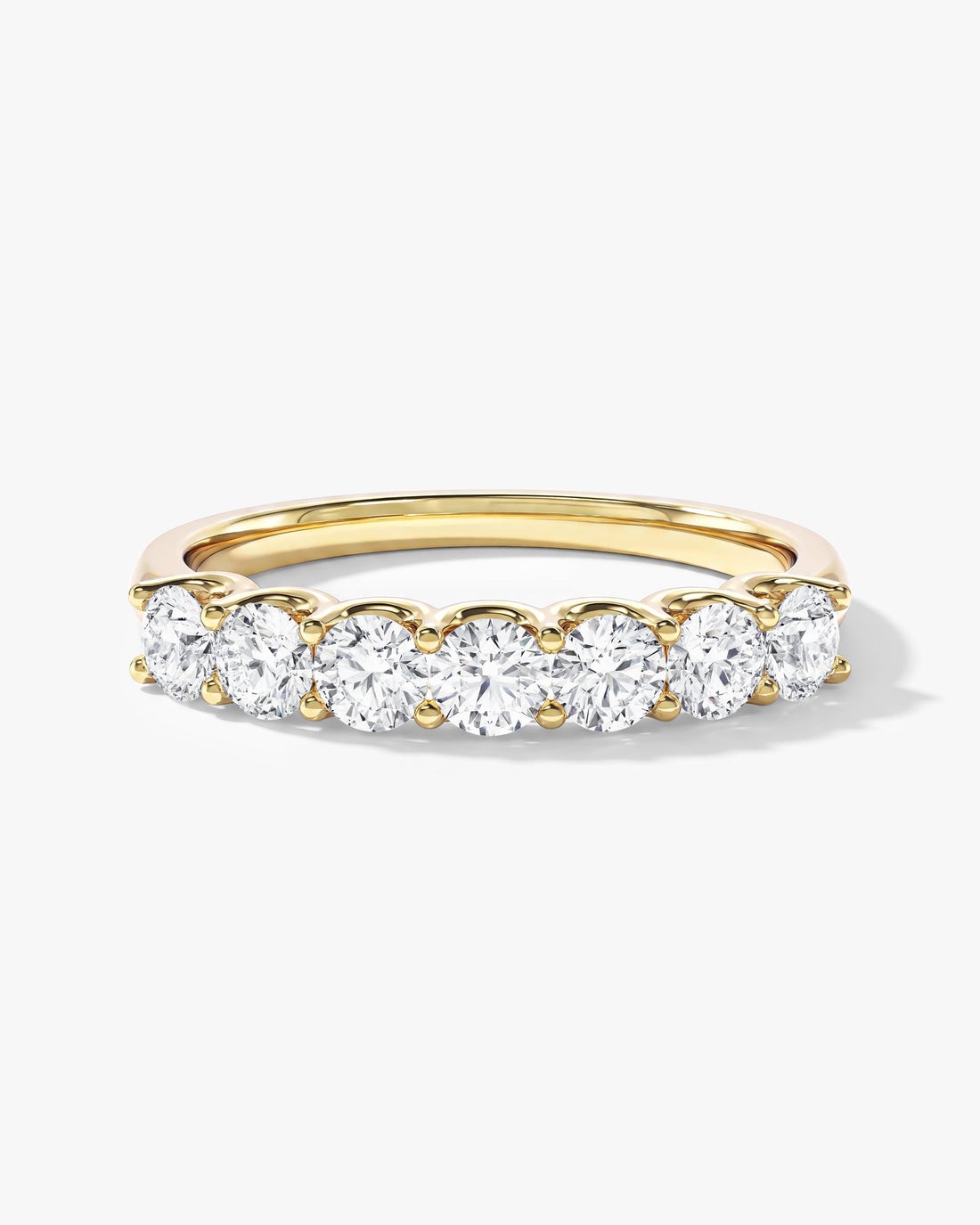 Round moissanite U-prong seven stone anniversary band in yellow gold, front view