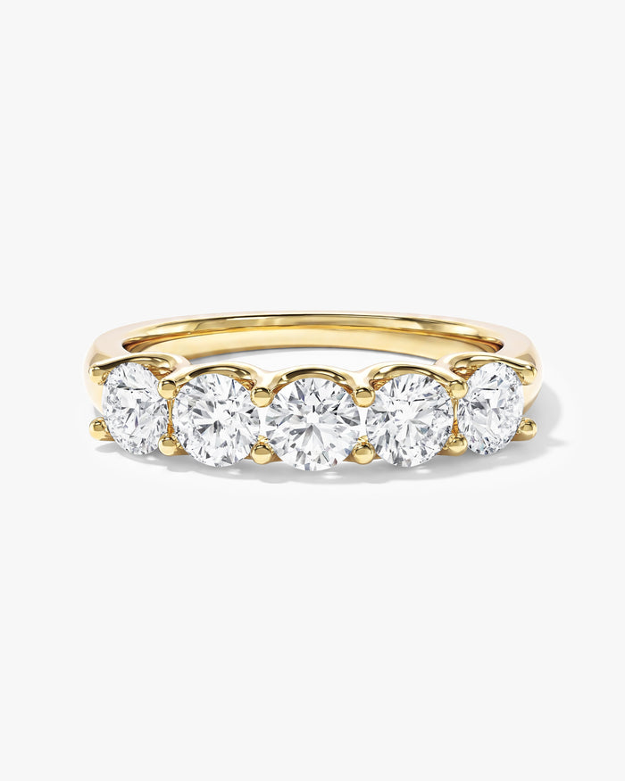 Round moissanite U-prong five stone anniversary band in yellow gold, front view