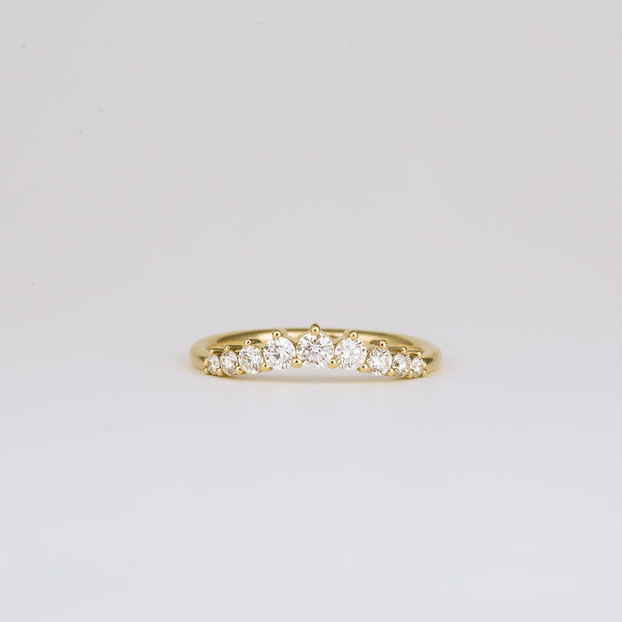 Round moissanite curved wedding band in yellow gold, front view