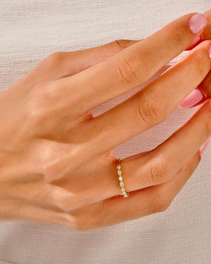 Milgrain marquise moissanite band worn on the finger, yellow gold