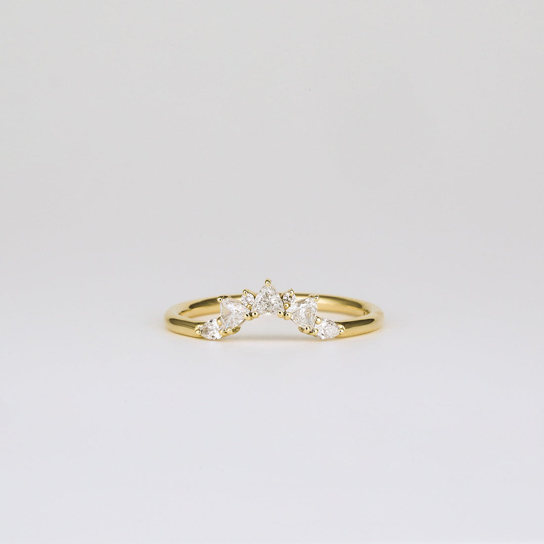 Round and trillion lab grown diamond curved cluster wedding band in yellow gold, front view