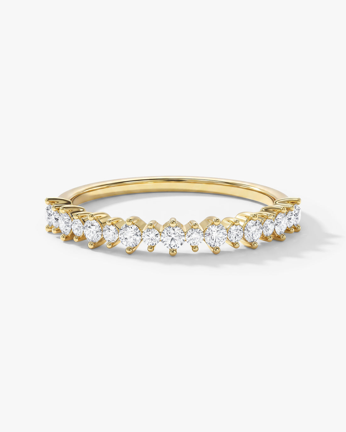 Round moissanite alternating prong half eternity wedding band in yellow gold, front view