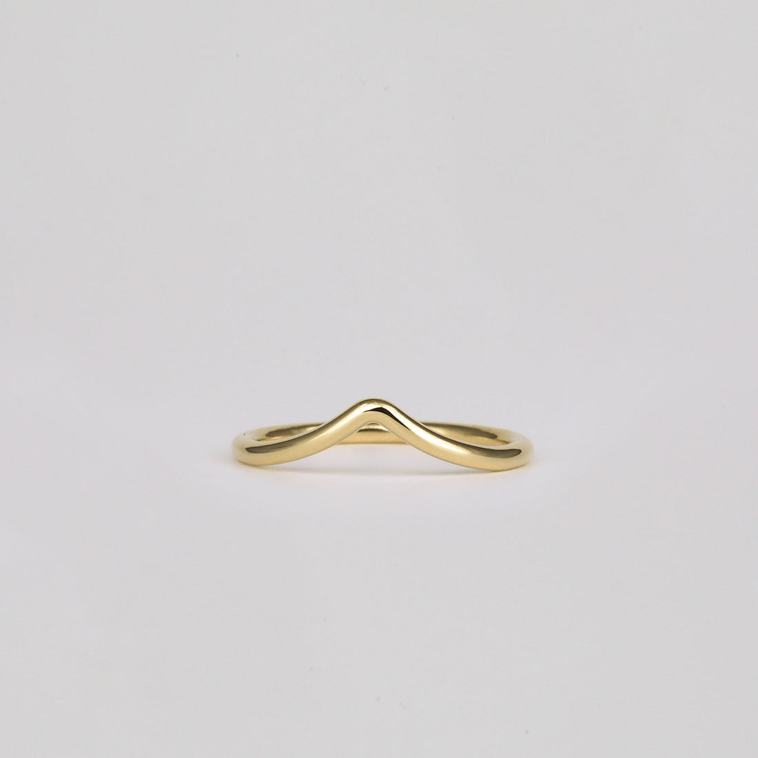Plain V shaped curved wedding band in yellow gold, front view