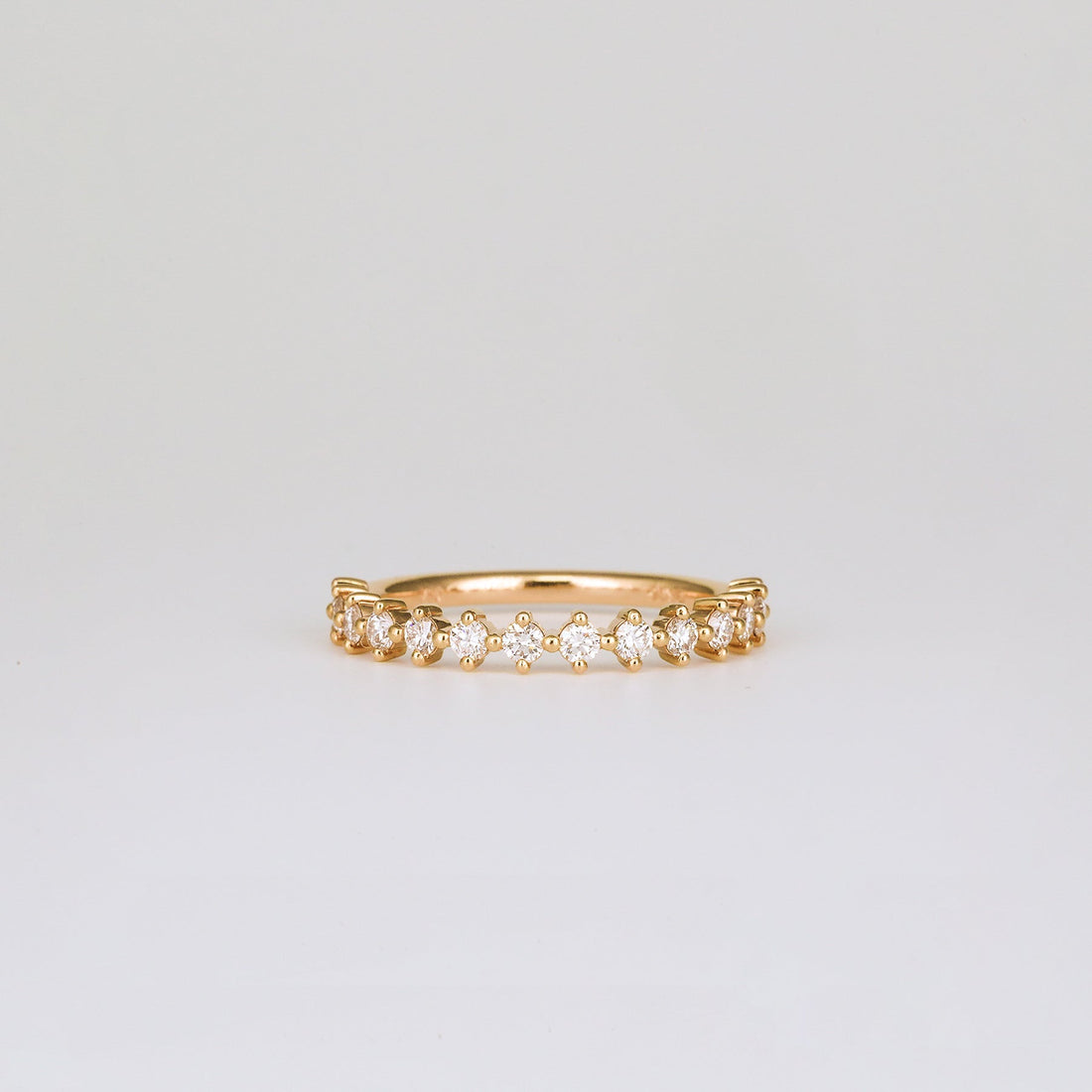 Round lab grown diamond four prong half eternity band in rose gold, front view
