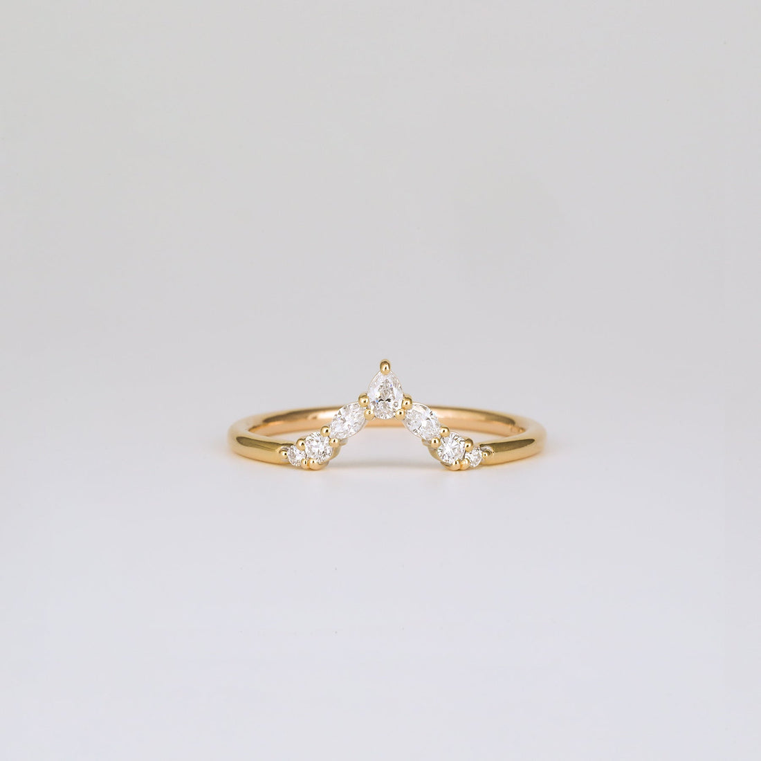 Pear, marquise and round lab grown diamond V shaped curved wedding band in yellow gold, front view