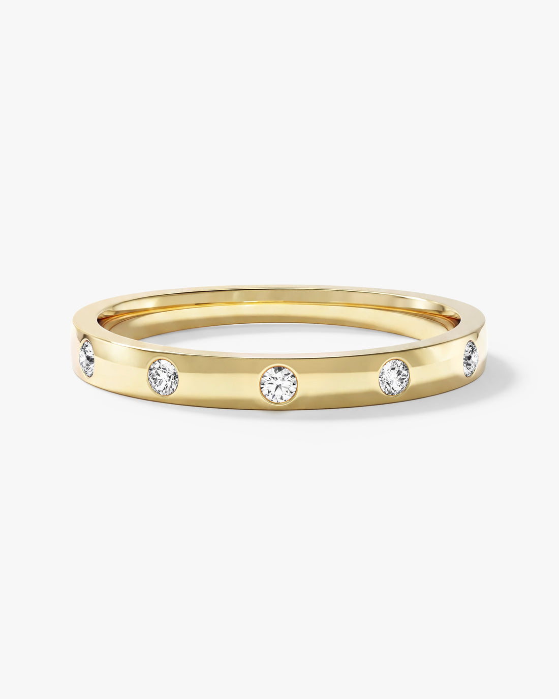 Round moissanite flush set wedding band in yellow gold