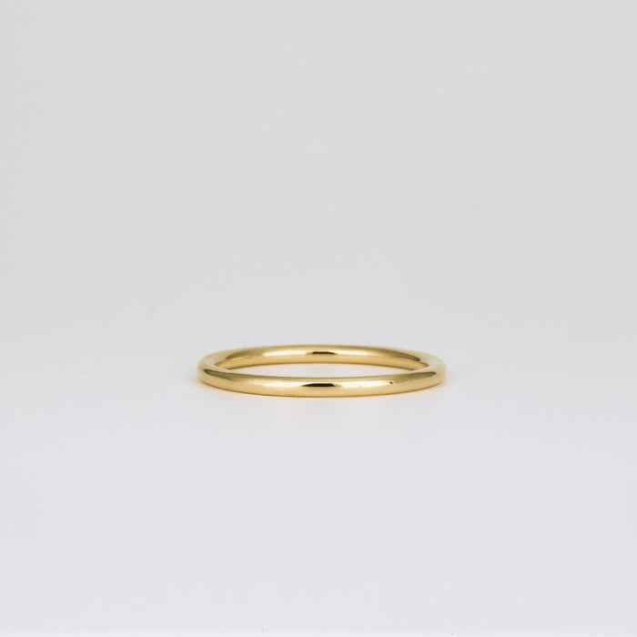 Plain slim round wedding band in yellow gold, front view