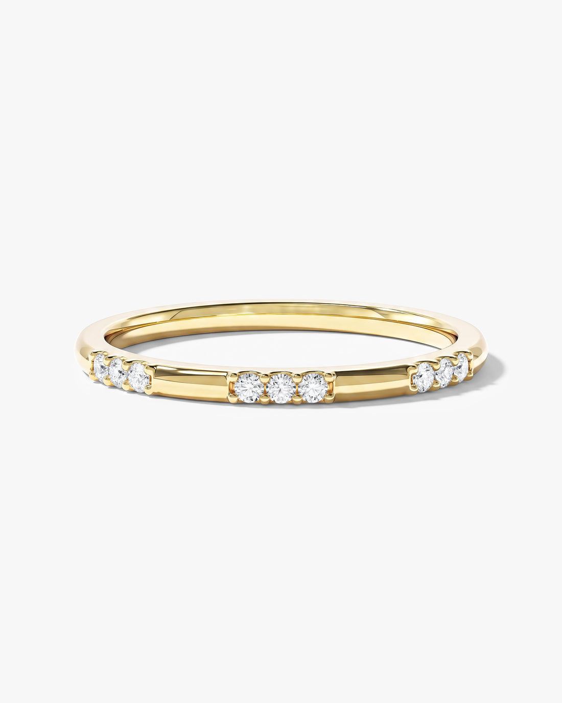 Round moissanite dainty nine-stone wedding band in yellow gold