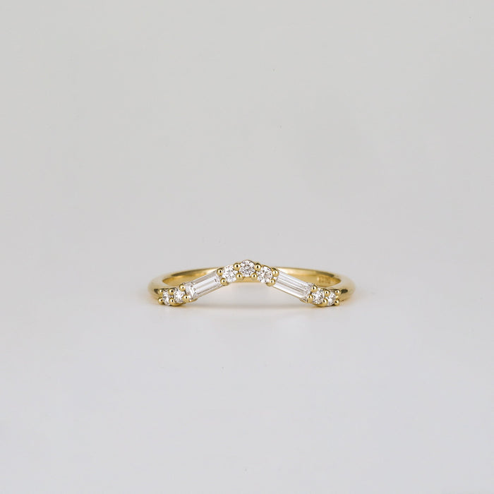 Baguette and round moissanite curved wedding band in yellow gold, front view