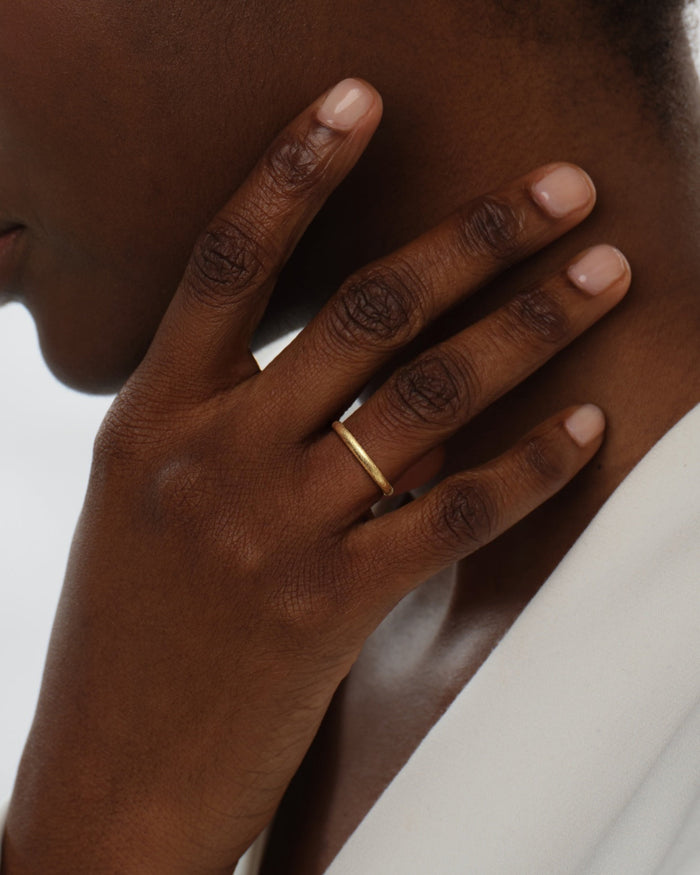 Ice matte dome wedding band worn on a hand