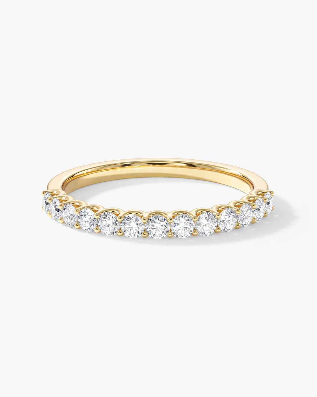 Round moissanite U-prong half eternity wedding band in yellow gold