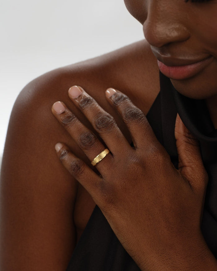 5mm gold ice matte wedding band worn on the hand near the shoulder
