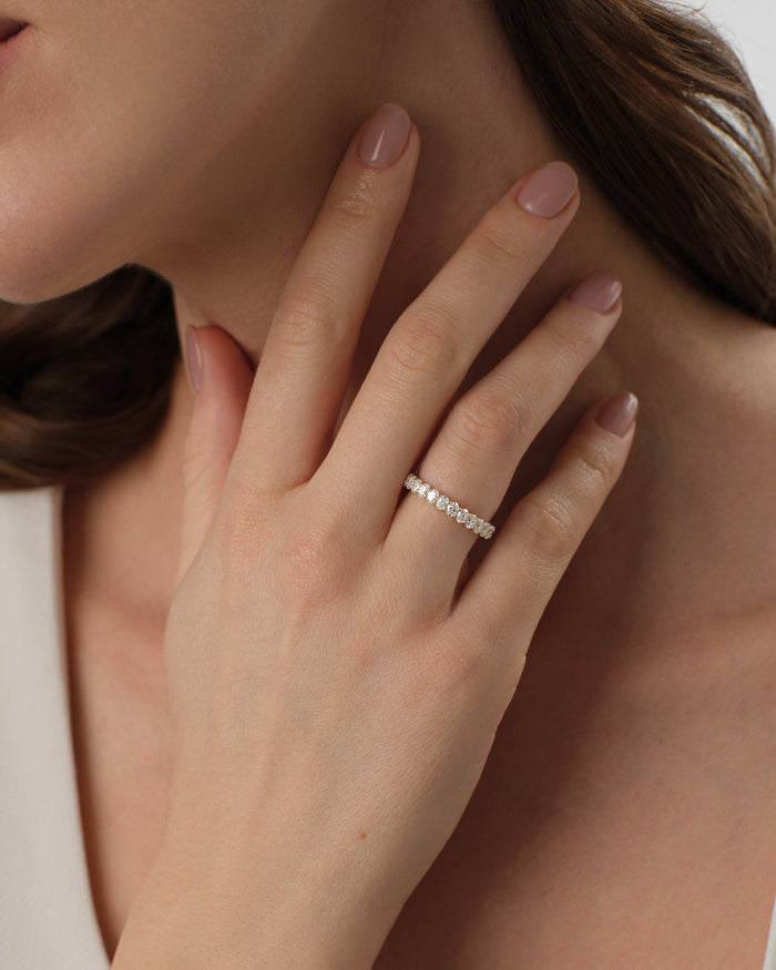Oval moissanite U-prong band worn on the hand