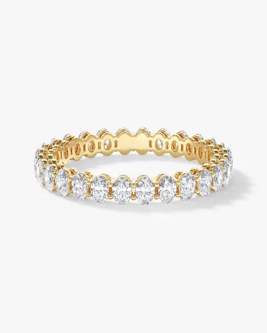 3.1mm oval moissanite shared prong eternity wedding band in yellow gold