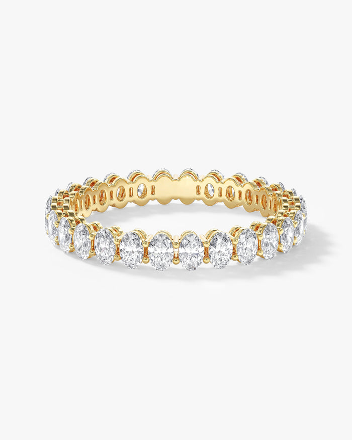 3.1mm oval moissanite shared prong eternity wedding band in yellow gold
