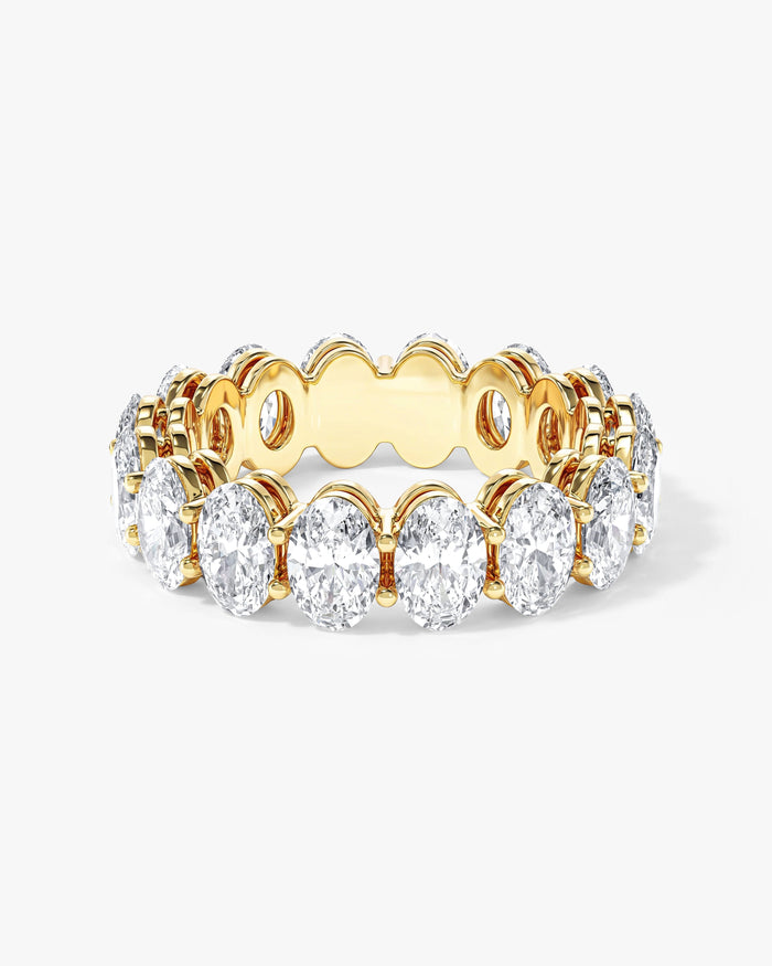 6mm oval moissanite shared prong eternity wedding band in yellow gold