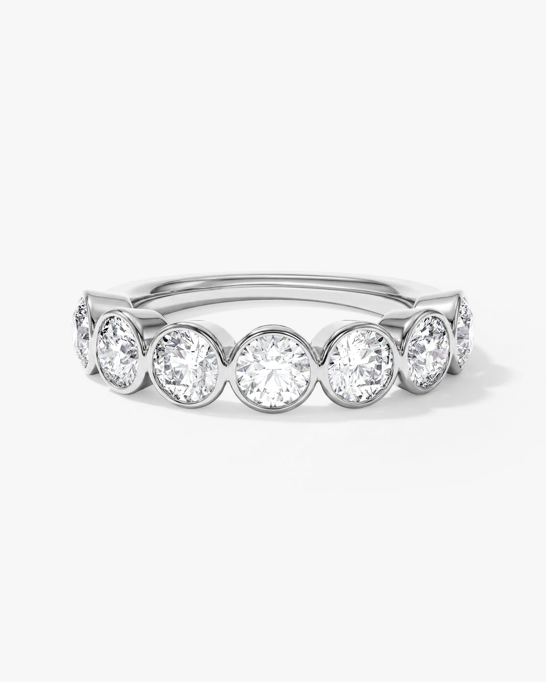 Round moissanite bezel half eternity wedding band in white metal, front view