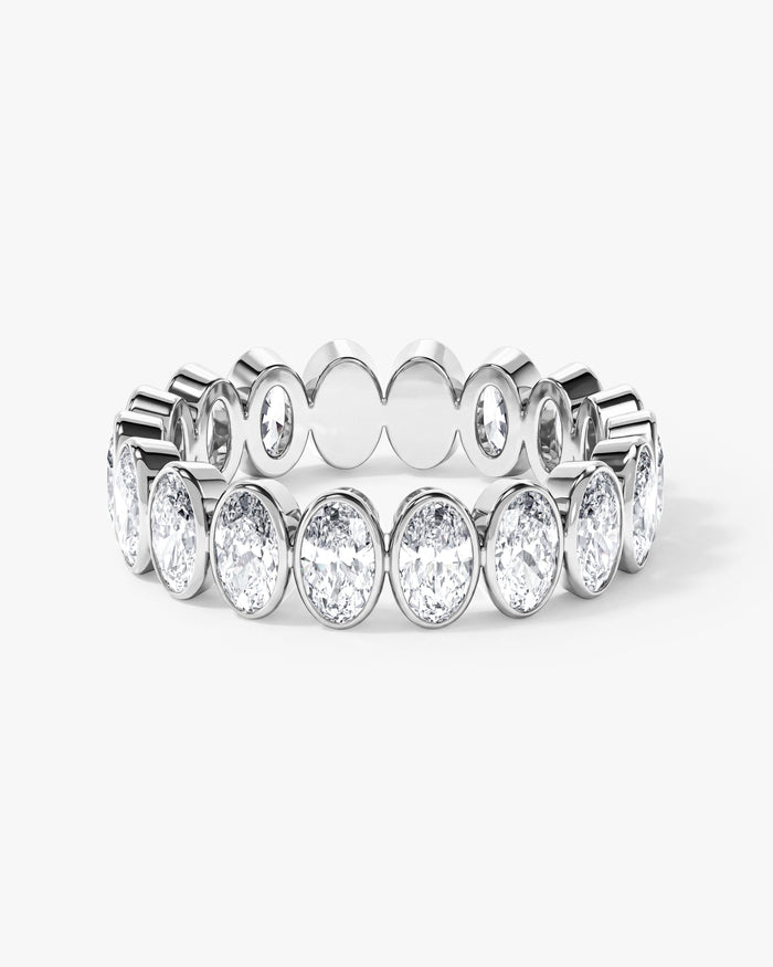 Oval moissanite bezel eternity wedding band in white metal, front view