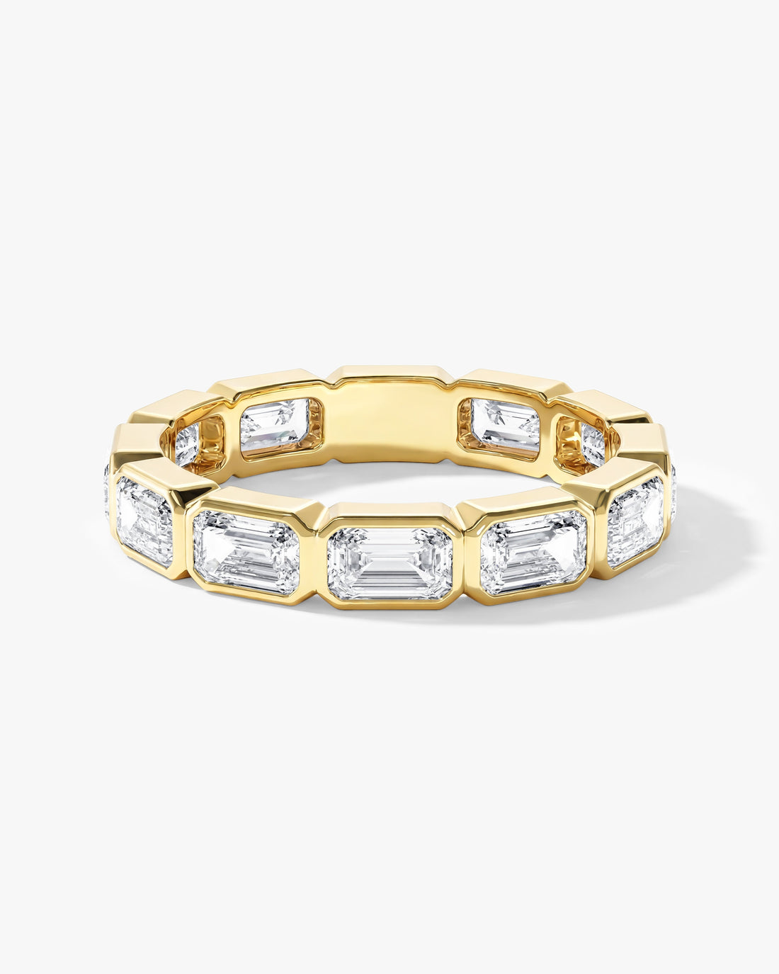 East-west emerald cut moissanite bezel eternity band in yellow gold, front view