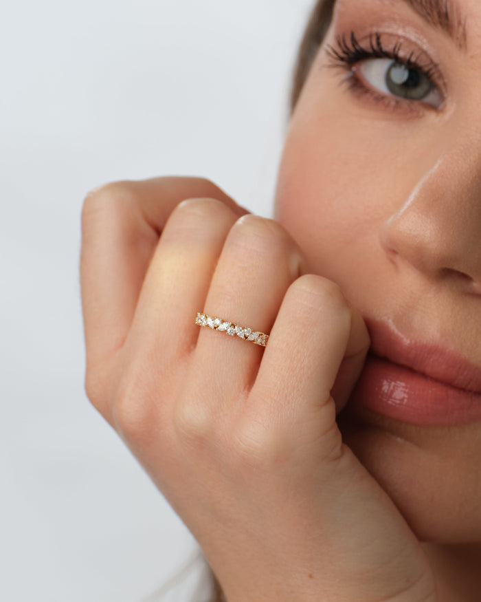 Marquise and round moissanite bloom band worn on a model's hand