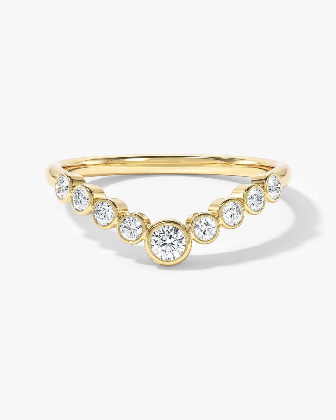 Round moissanite bezel set curved wedding band in yellow gold with graduated stones