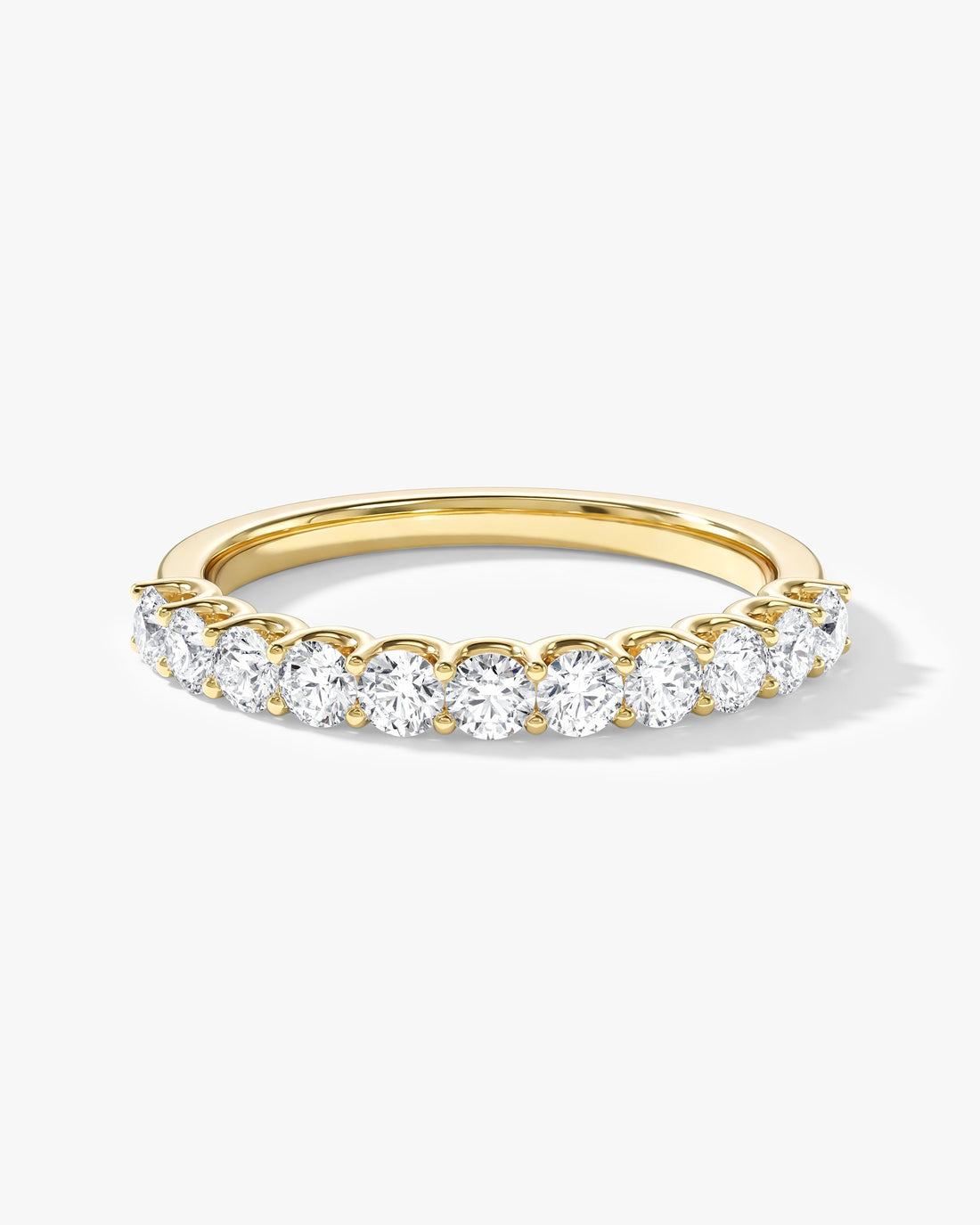 Round moissanite U-prong half eternity wedding band in yellow gold