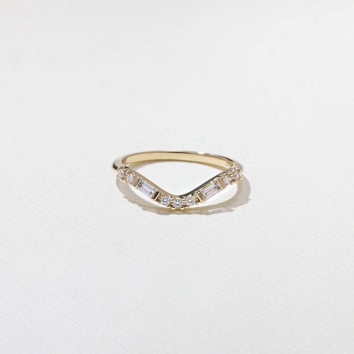 Round and baguette moissanite curved wedding band front view