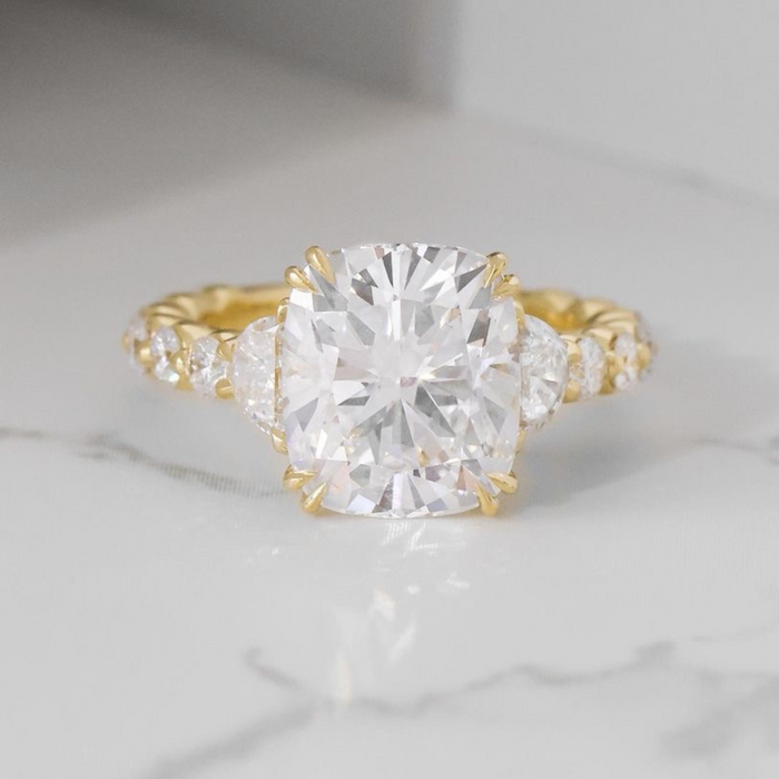 Cushion cut moissanite 3 stone engagement ring with half moon side stones in gold