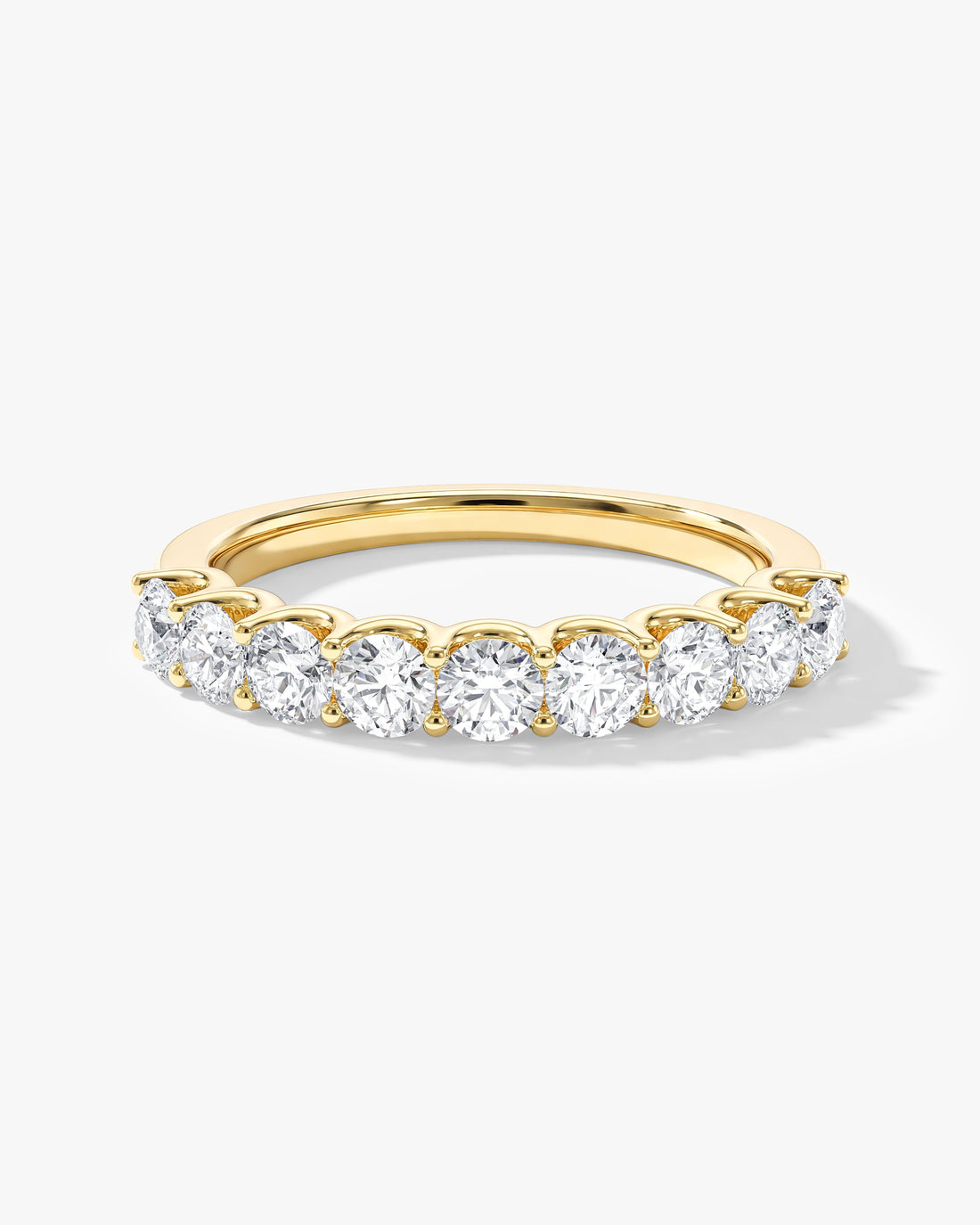 Round moissanite U-prong half eternity wedding band in yellow gold