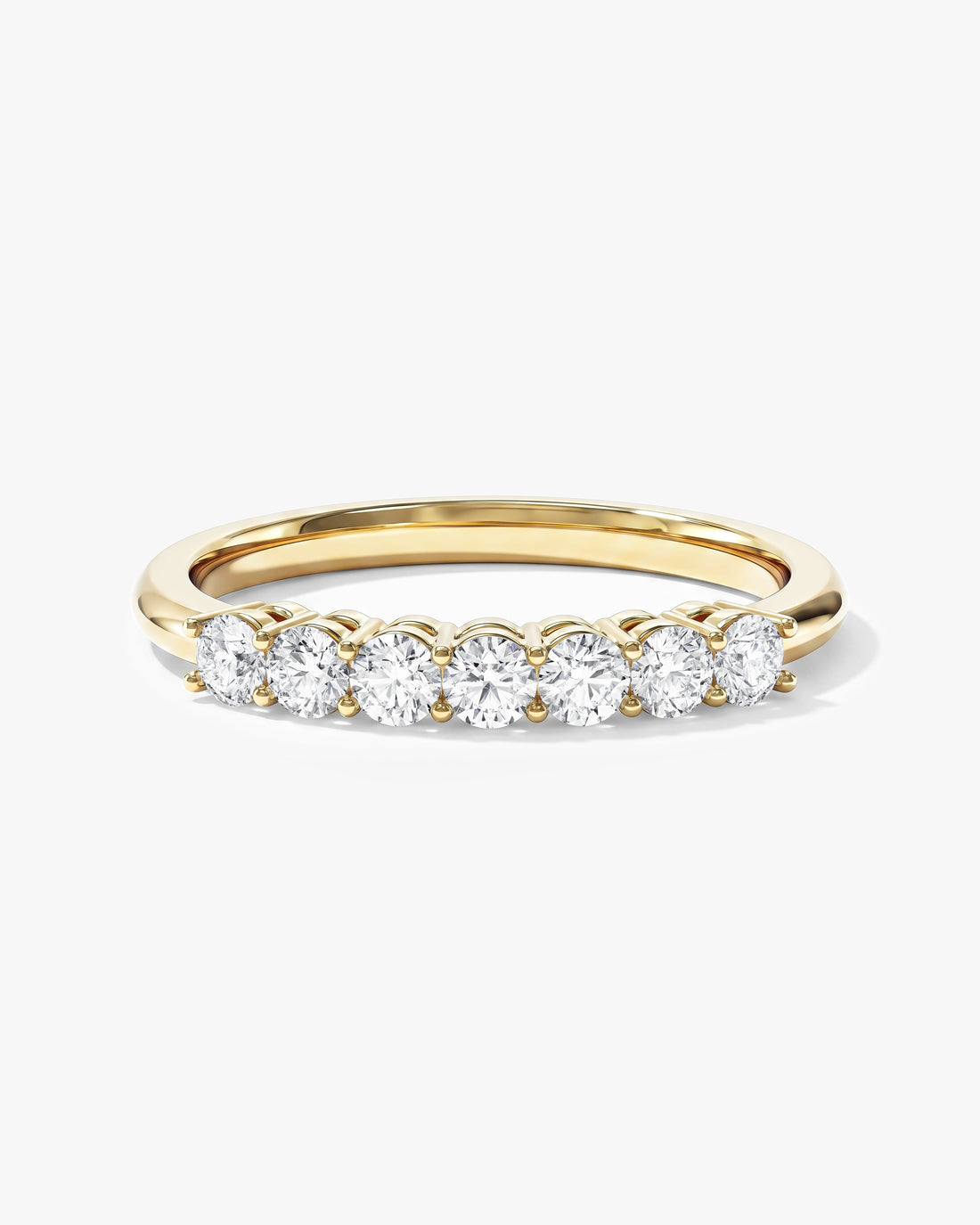 Round moissanite classic seven stone anniversary wedding band in yellow gold, front view