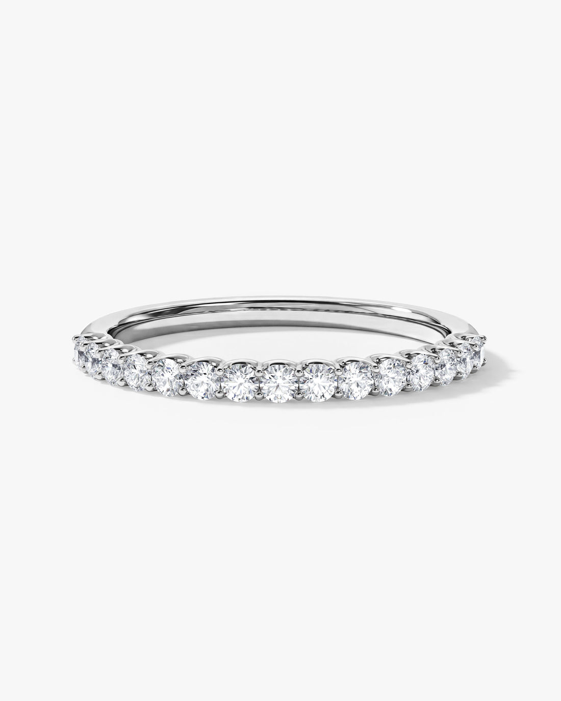 Round moissanite U-prong half eternity wedding band in white gold