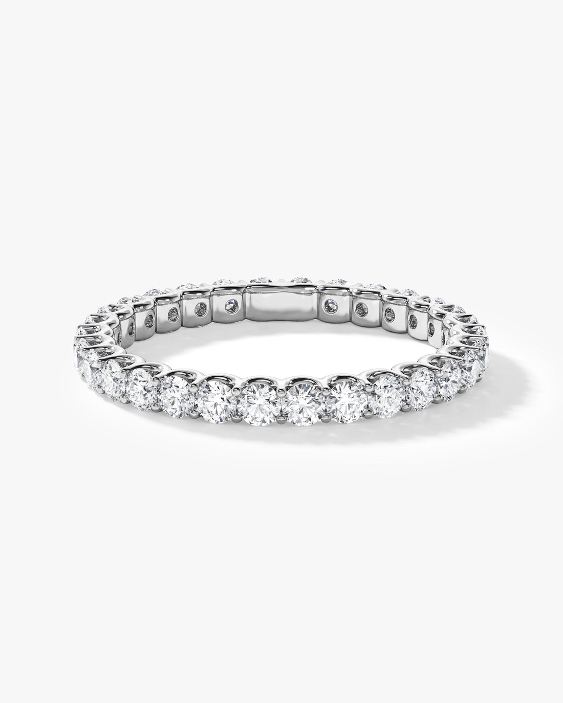 Round moissanite U-prong eternity wedding band in white metal