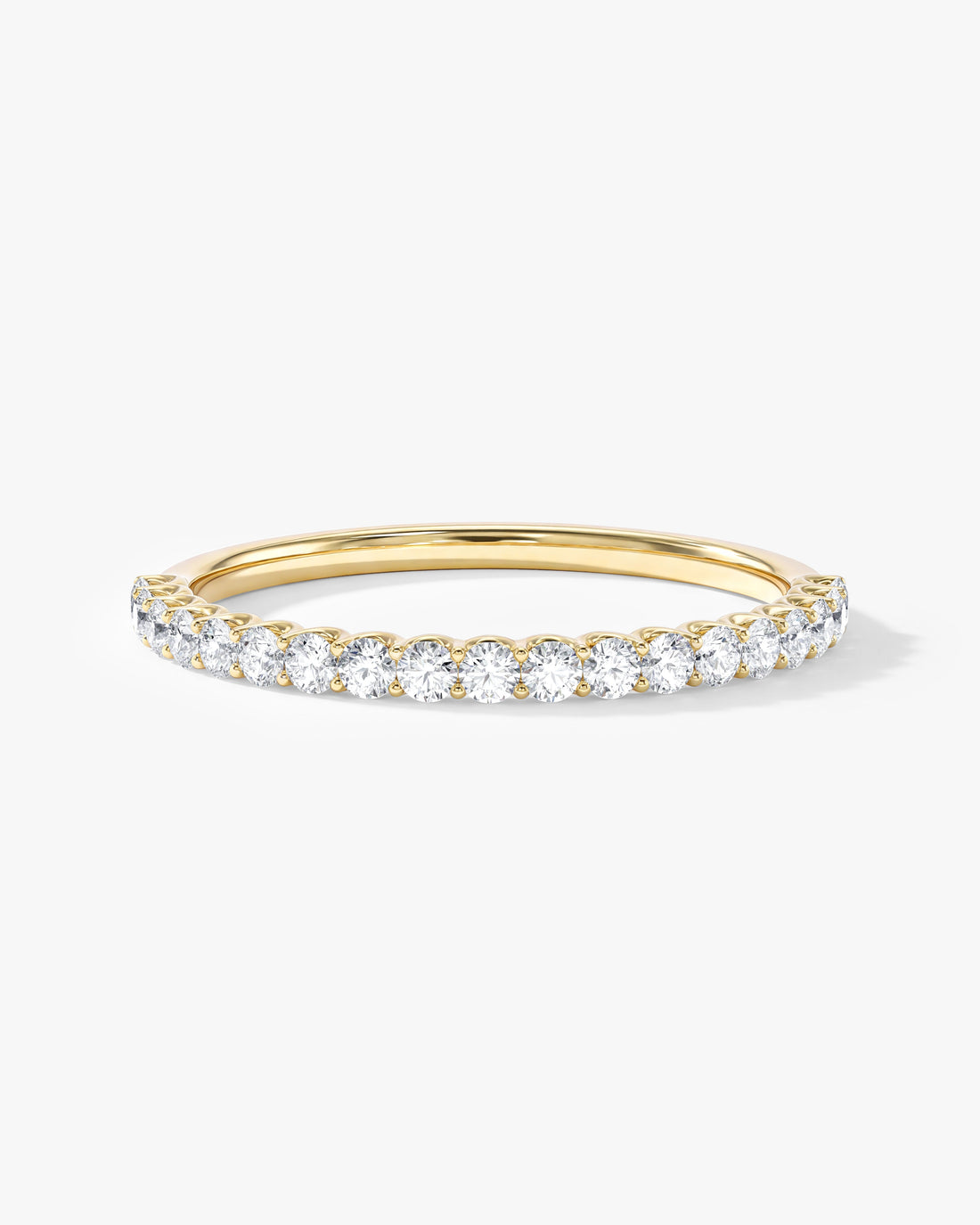 Round moissanite U-prong half eternity wedding band in yellow gold