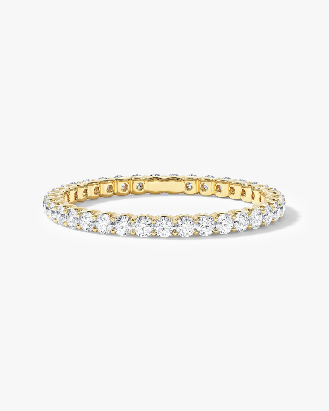 Round moissanite U-prong full eternity wedding band in yellow gold