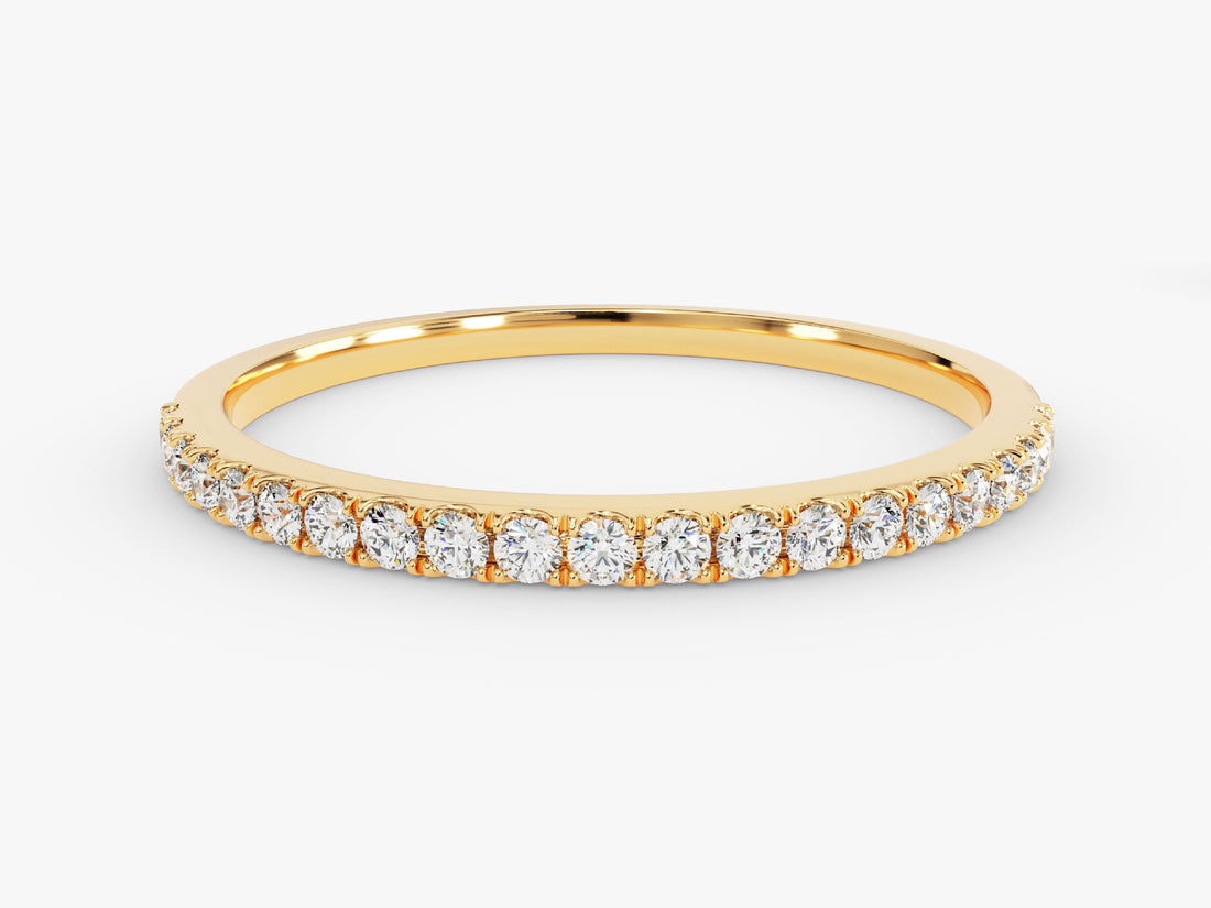 Round moissanite 4-prong half eternity wedding band in yellow gold