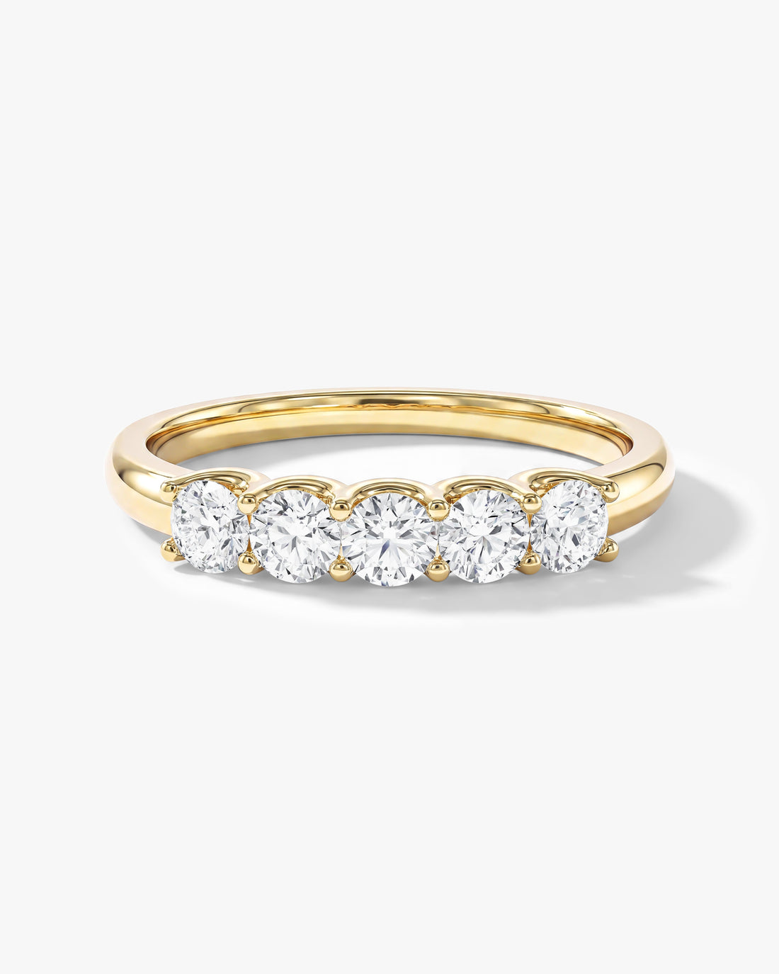 Round moissanite U-prong five stone anniversary wedding band in yellow gold, front view