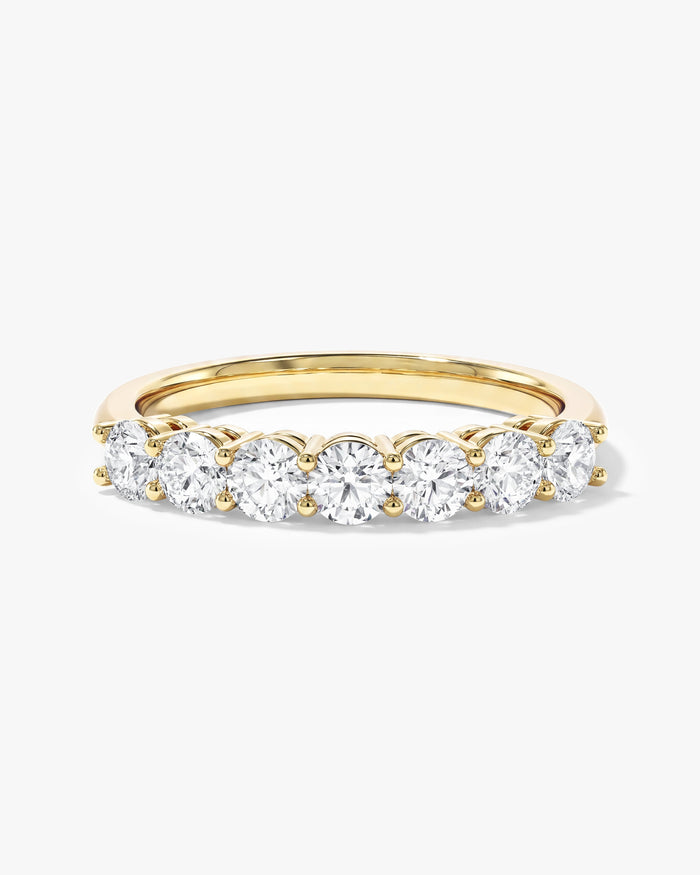 Round moissanite seven stone anniversary band in yellow gold, front view