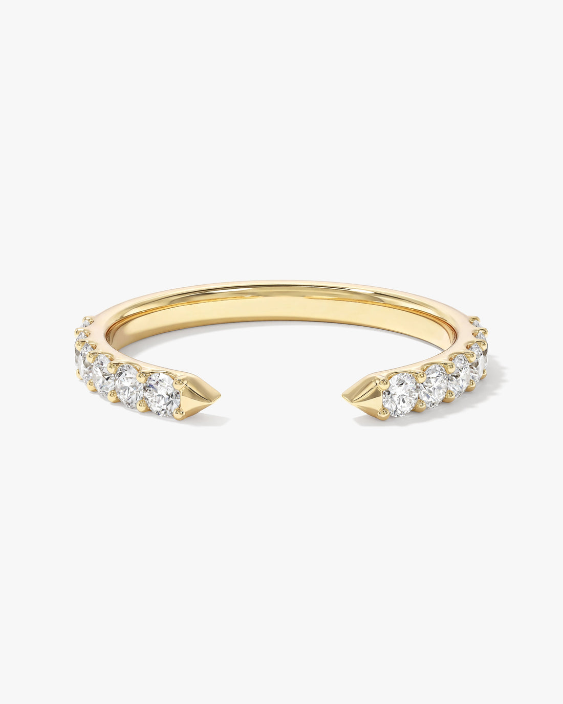 Round moissanite shared prong open cuff wedding band in yellow gold