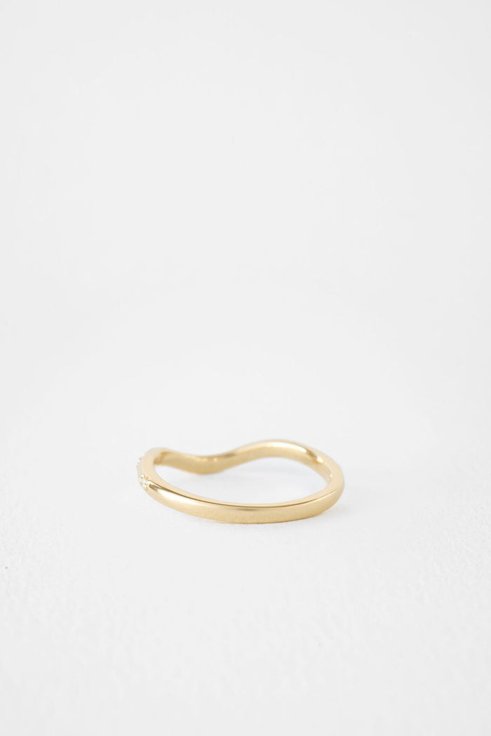 Curved moissanite wedding band, side view